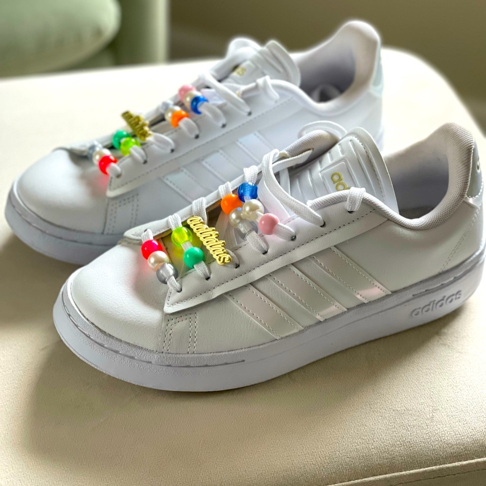 Womens adidas size 7 sneakers with beaded laces.